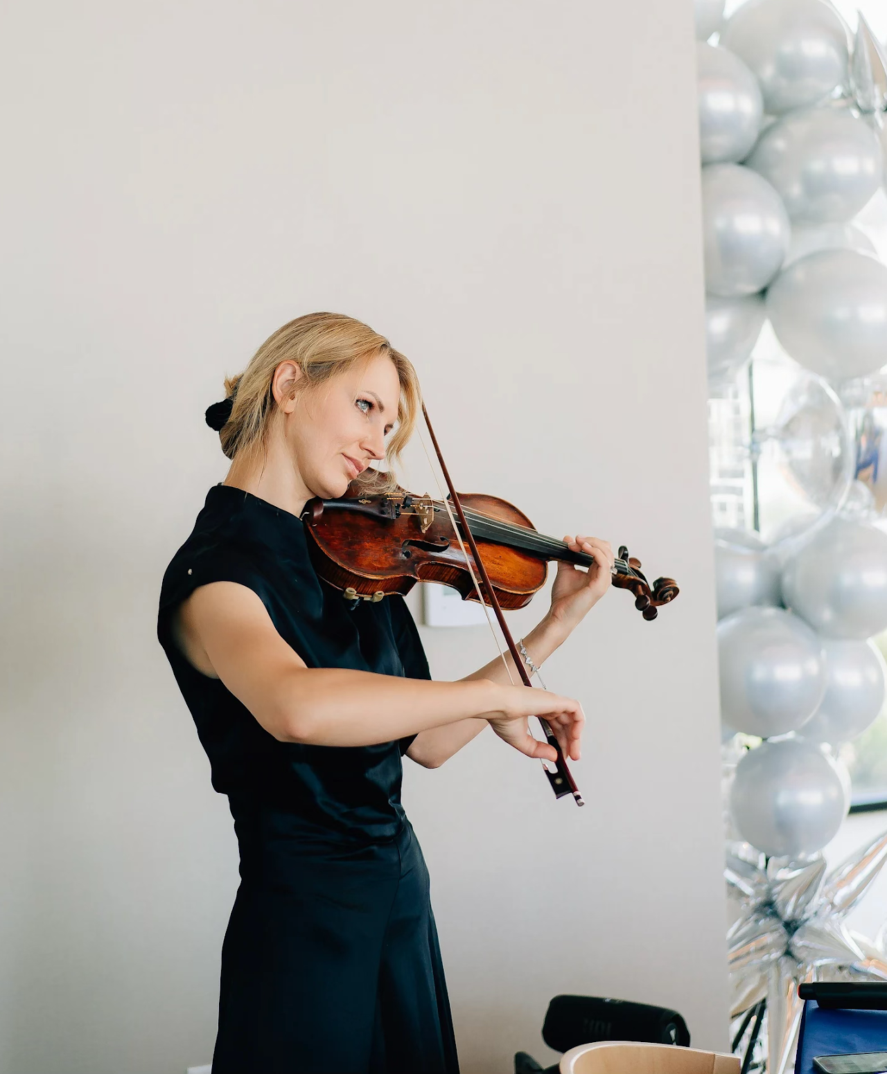 Mila performing violin at an event